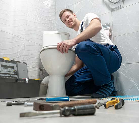 a plumber checking toilet-leaks-during plumbing inspection